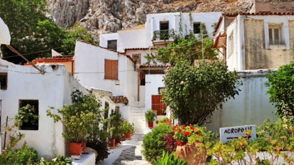 Charming Whitewashed Houses With  Narrow Stairs In The Anafiotika Neighborhood Below The Acropolis In Athens